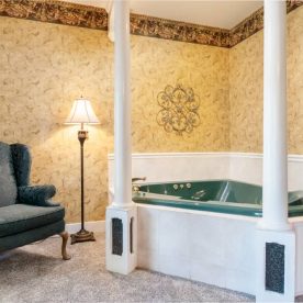 Two person jetted tub in a room with carpet