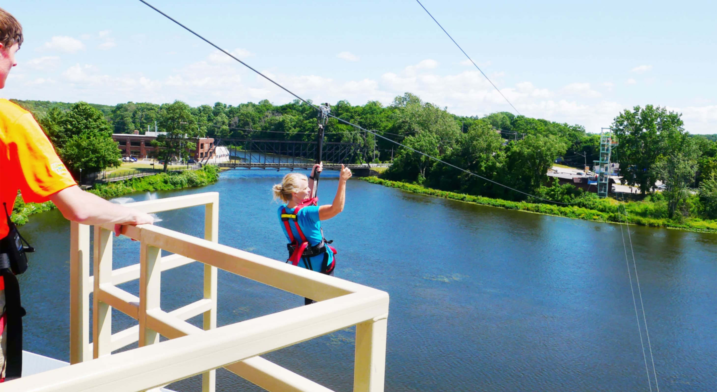 Woman takes off from a platform on a zipline in Allegan